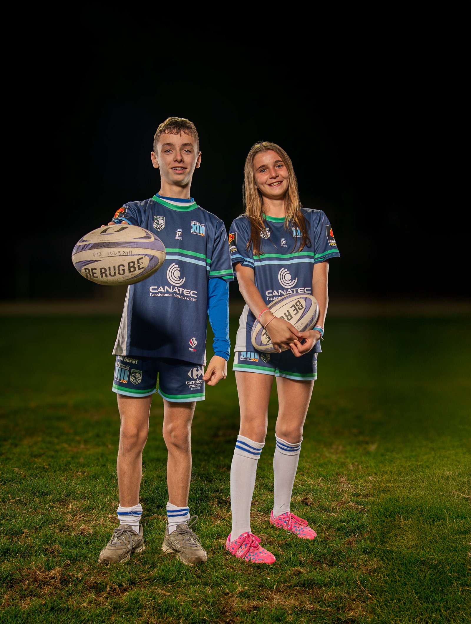 Jeunes joueurs du FC Ille-sur-Têt posant en tenue officielle sur le terrain de football de nuit.